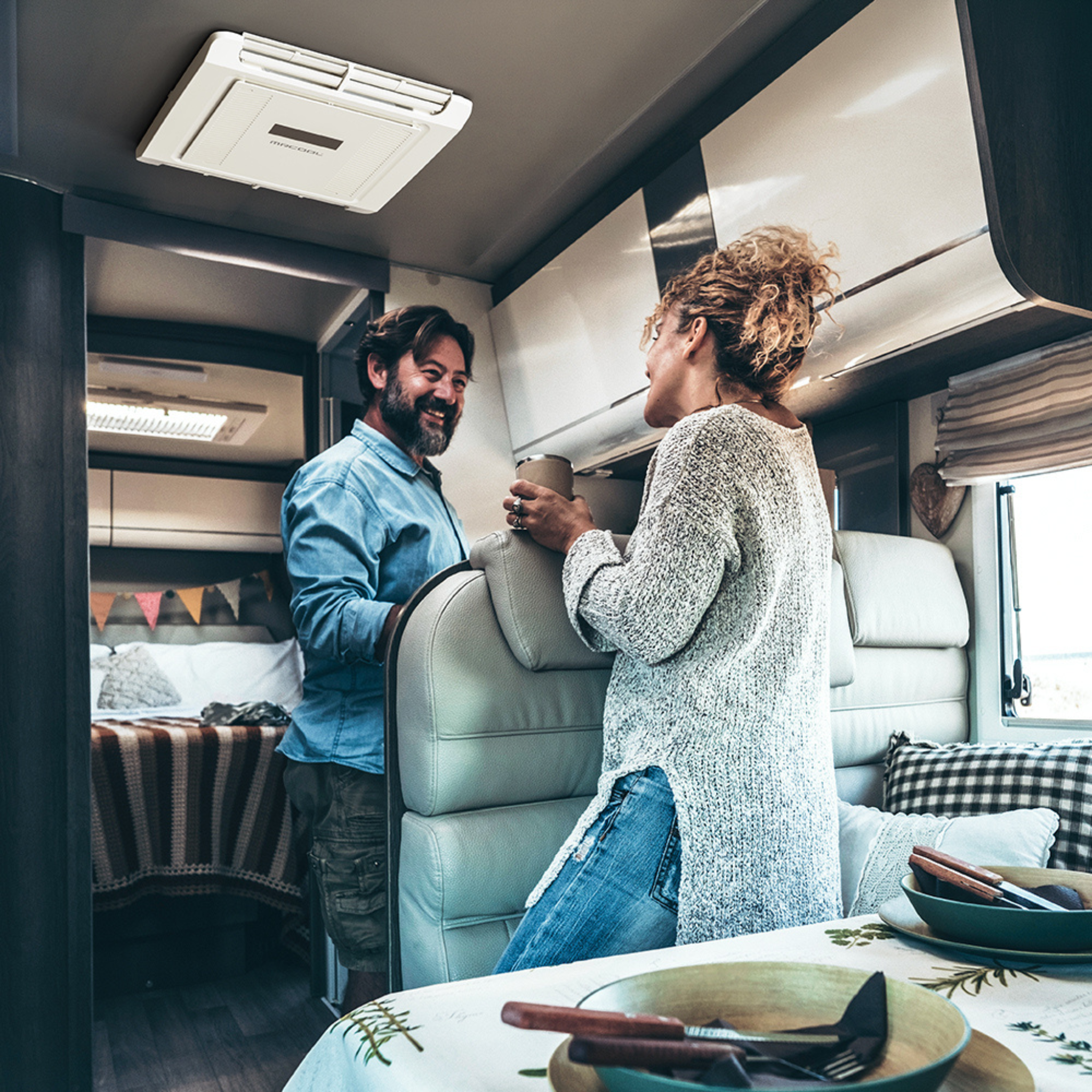 Interior view of the MRCOOL® TravelCool™ 15,000 BTU RV inverter heat pump air distribution assembly installed in a travel trailer, providing quiet heating and cooling comfort with a ceiling-mounted air outlet, WiFi-enabled controls, and inverter technology,